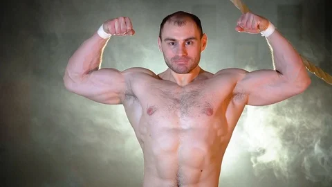 The bodybuilder demonstrates his muscles Stock Footage 86082626