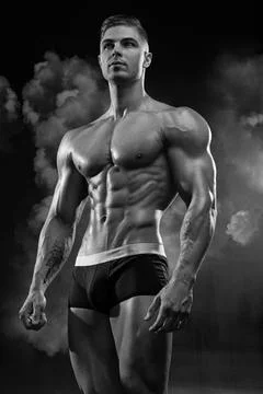 Bodybuilder demonstrates a pumped up body without clothes Stock Photos