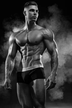 Bodybuilder demonstrates a pumped up body without clothes Stock Photos