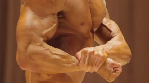 Bodybuilder demonstrating strong body in side chest and rear double bicep poses 스톡 동영상 65330447