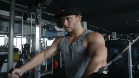 Bodybuilder does cable crossover fly Stock Footage 85613703
