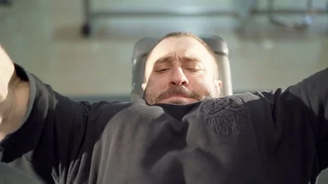 The bodybuilder does exercise with a bar 動画素材 75242535