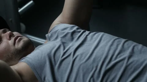 Bodybuilder is doing bench press Stock Footage 85617004