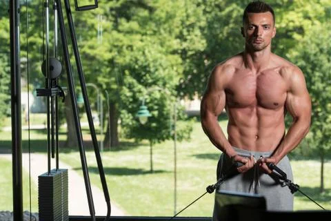 Bodybuilder Doing Exercise For Chest On Machine Stock Photos