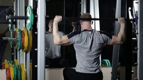Bodybuilder doing exercise on shoulders Stock Footage 76168247