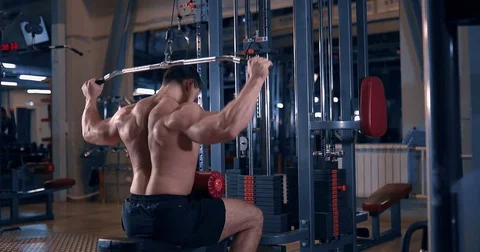 bodybuilder doing exercise on the simula... | Stock Video | Pond5