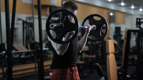 Bodybuilder doing exercises with barbell Stock Footage 62744645