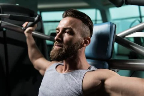 Bodybuilder Doing Heavy Weight Exercise For Shoulders Stock Photos