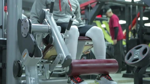 Bodybuilder Doing Leg Extension Workout Exercise In A Modern Gym Stock Footage 143121113