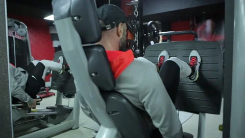 Bodybuilder Doing Leg Extension Workout Exercise In A Modern Gym Stock Footage 143121194