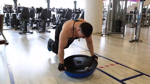Bodybuilder is doing the leg witha pilates ball at the gym Stock Footage 75992116