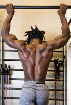 Bodybuilder Doing Pull-ups in the Gym Stock Photos