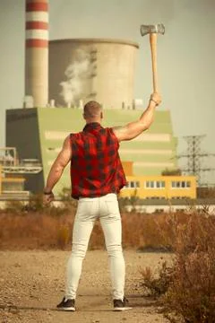 Bodybuilder with double edge axe posing and working out Stock Photos