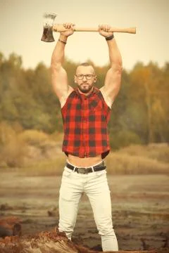 Bodybuilder with double edge axe posing and working out Stock Photos