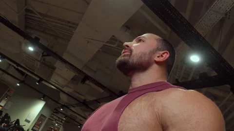 Bodybuilder drinks water from bottle after sports workout in the gym. Healthy Video stock 189951832