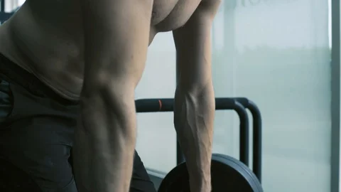 Bodybuilder exercising with a barbell at the gym Stock Footage 127437528