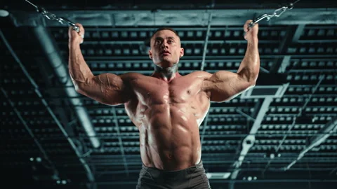 Bodybuilder Exercising Biceps at Crossover Machine in Gym Stock Footage 270486043