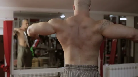 Bodybuilder exercising biceps at gym Stock Footage 65284384