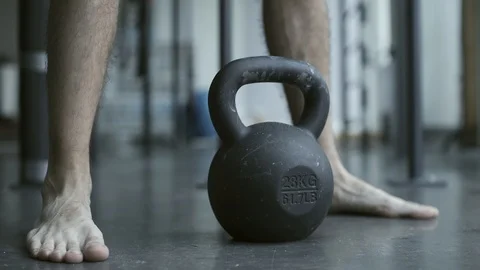 Bodybuilder exercising with a kettlebell at the gym Stock Footage 127438686