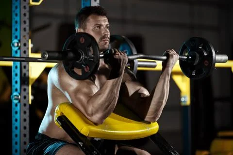 Bodybuilder exercising with weights Stock Photos