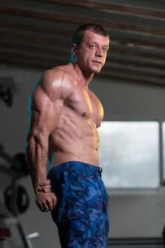 Bodybuilder Flexing Muscles Stock Photos