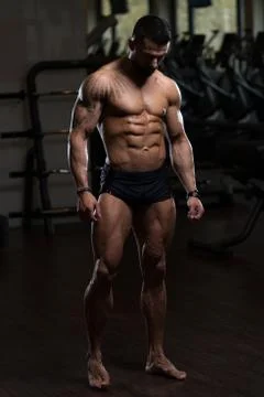 Bodybuilder Flexing Muscles Stock Photos