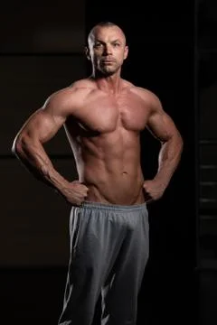 Bodybuilder Flexing Muscles Stock Photos