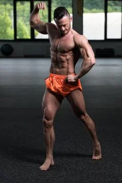 Bodybuilder Flexing Muscles Stock Photos