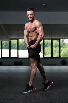 Bodybuilder Flexing Muscles Stock Photos