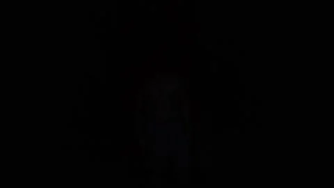 A bodybuilder goes to the light in a dark room Stock Footage 130300455