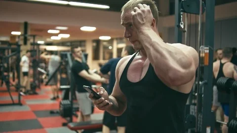 Bodybuilder in gym doing selfie Stock Footage 90308024