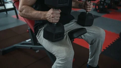 Bodybuilder holding dumbbells. Loop Stock Footage 82354489