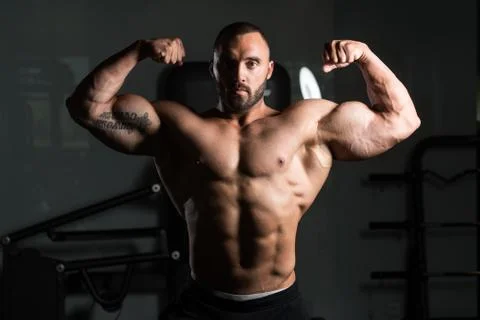 Bodybuilder Man Posing In The Gym Stock Photos