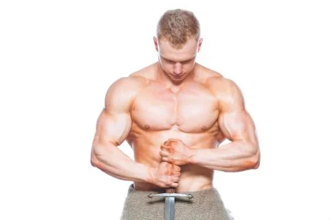 Bodybuilder man posing with a sword isolated on white background. Serious Stock Photos