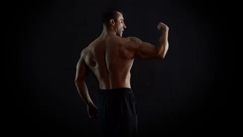 Bodybuilder Man Show His Torso and Arm Muscles 4K Video Stock Footage 73094879