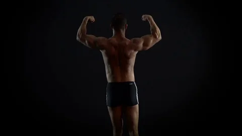 Bodybuilder Man Show His Torso and Arm Muscles 4K video Stock Footage 73095028