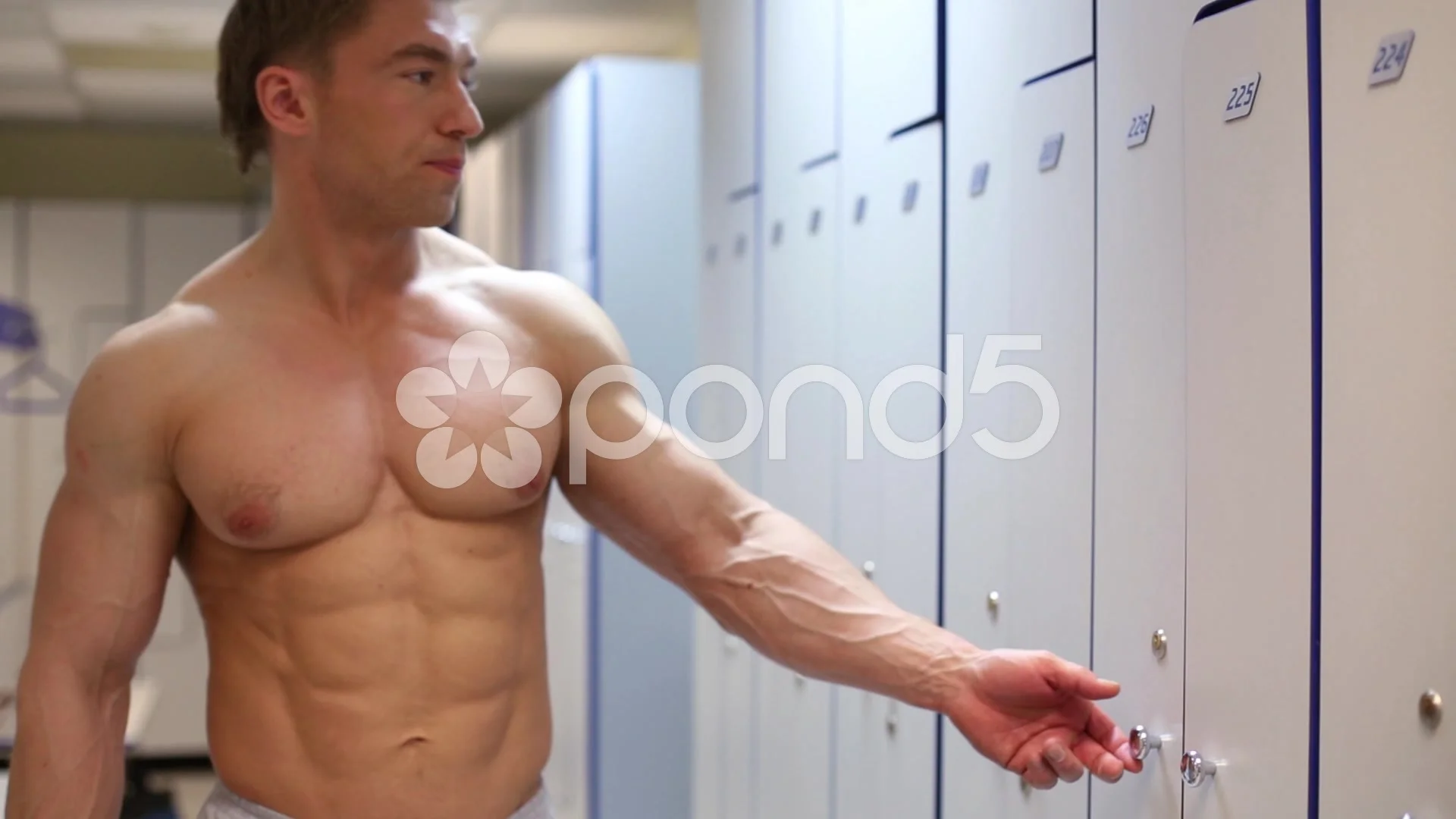Bodybuilder opens door in locker room af... | Stock Video | Pond5
