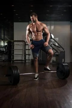 Bodybuilder Performing Back Exercising With Barbell In Gym Stock Photos