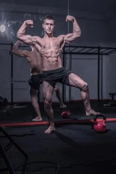 Bodybuilder posing, arms outstretched 스톡 사진