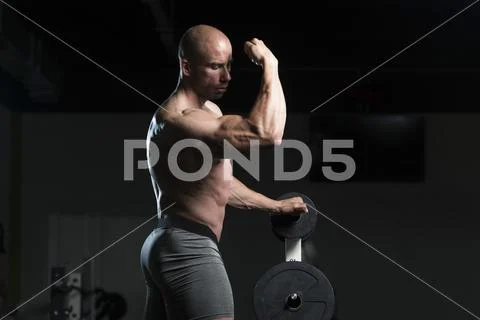 Bodybuilder Posing Biceps After Exercises Stock Photos