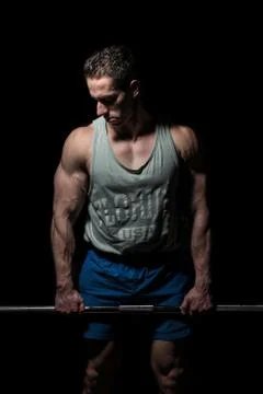 Bodybuilder posing on black background Stock Photos
