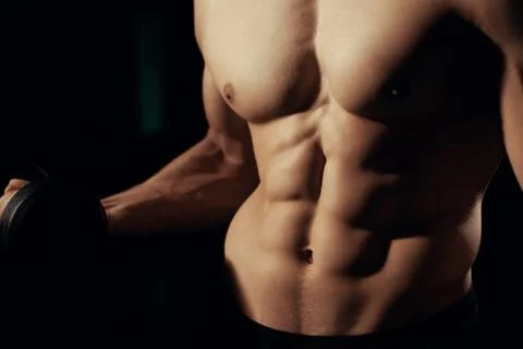 Bodybuilder posing with dumbbells Stock Photos