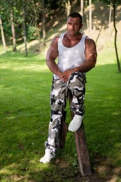 Bodybuilder posing in a field Stock Photos