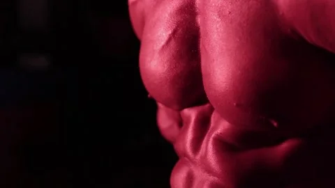 Bodybuilder posing in red light Stock Footage 132181827