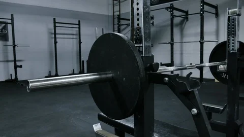 Bodybuilder / Powerlifter adding weight to barbell benchpress Stock Footage