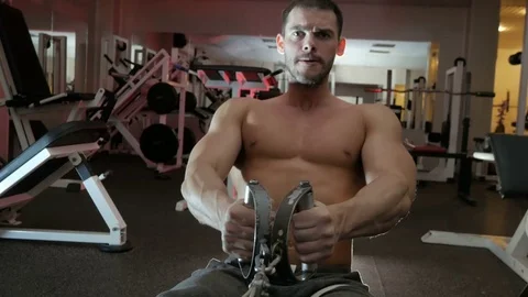 Bodybuilder pulls weight on himself Stock Footage 75807576