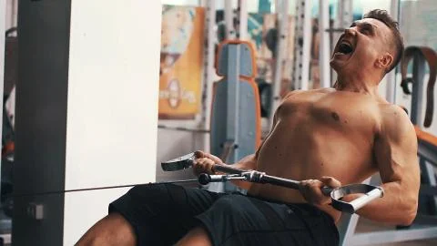 Bodybuilder pulls weight Stock Photos