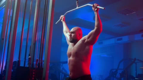 Bodybuilder with pumped muscles is perfo... | Stock Video | Pond5