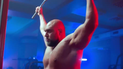 Bodybuilder with pumped muscles is perfo... | Stock Video | Pond5