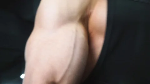 Bodybuilder pumping biceps with dumbbells Stock Footage 123347984